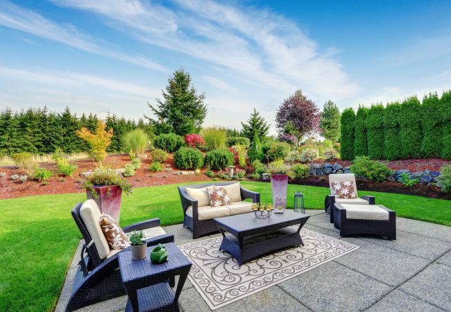 Impressive backyard landscape design with patio area